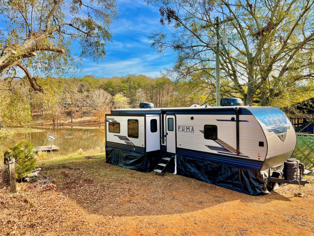 Temporary RV home set up by the family pond.